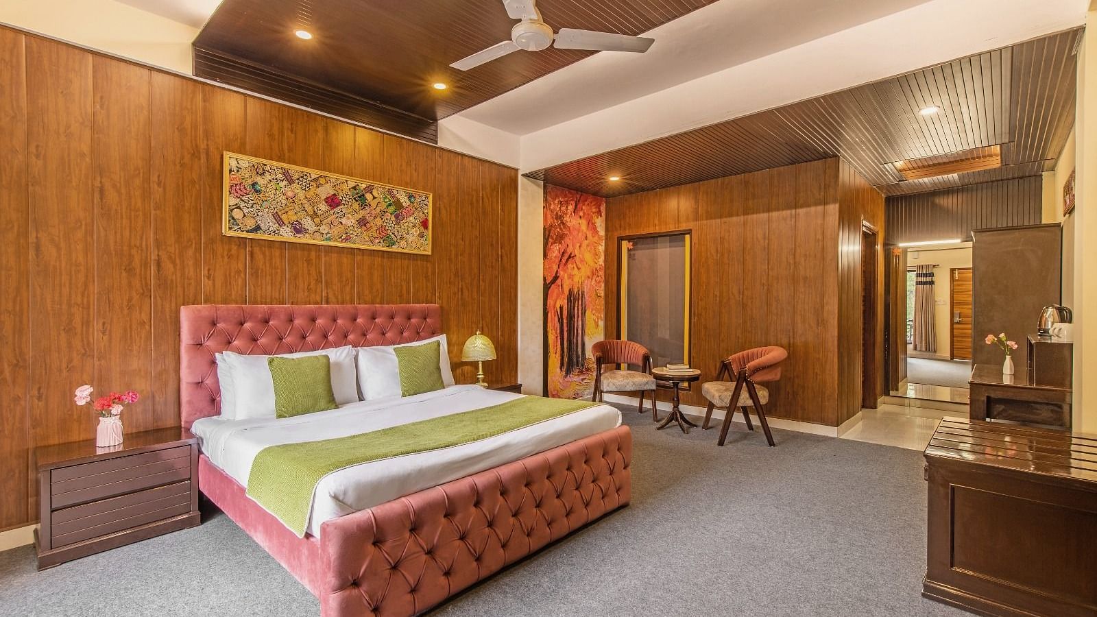 Super Deluxe Room featuring a king-sized bed, vibrant accents and a seating area | ZENQ MAPLE RESORT, CHAIL